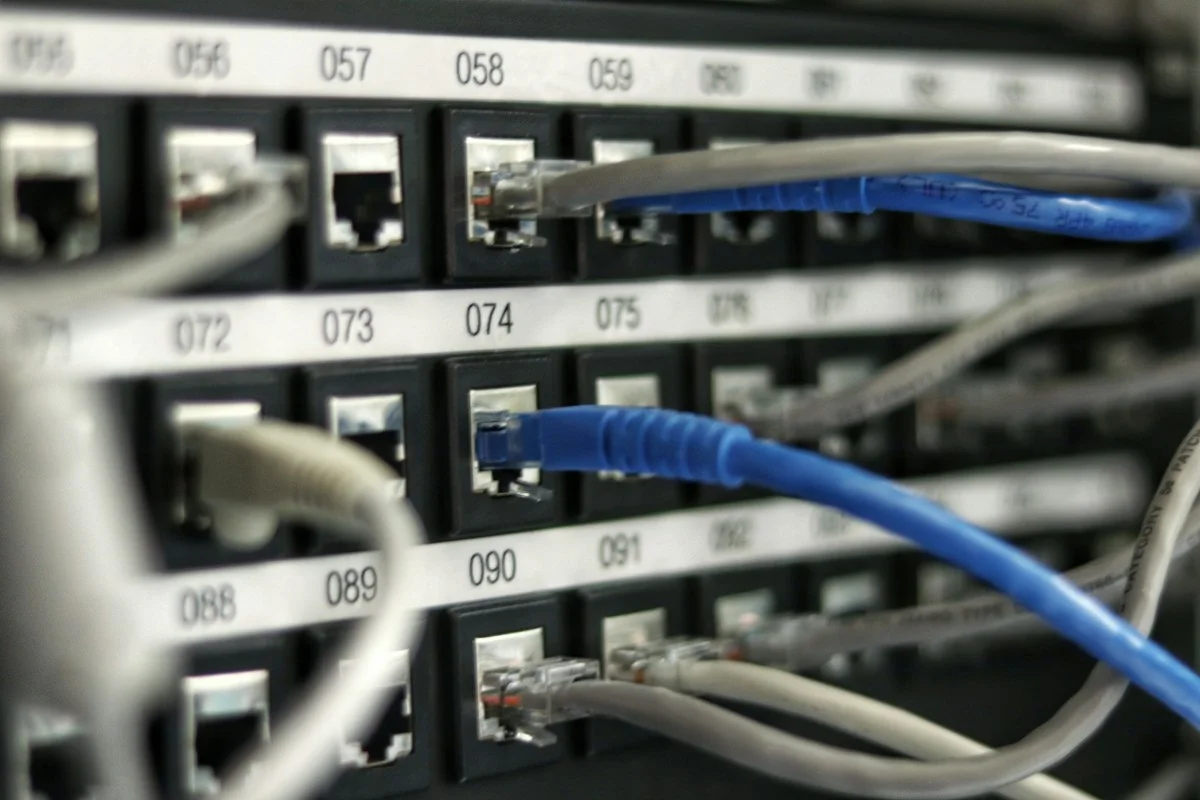 High-density fiber optic cross-connect patch panels inside enterprise colocation meet-me room